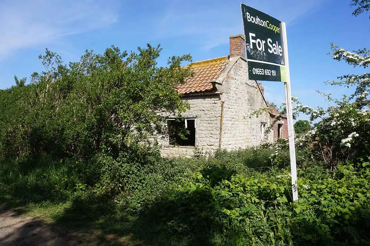 Photo showing a derelict property for sale in the UK.
