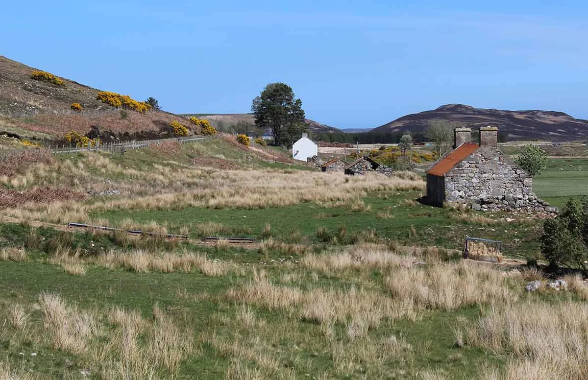 Photo of some empty buildings on land in Scotland.