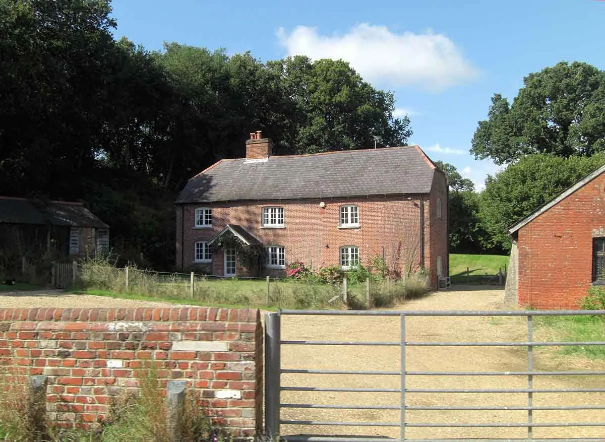 A rural house with land and outbuildings for sale