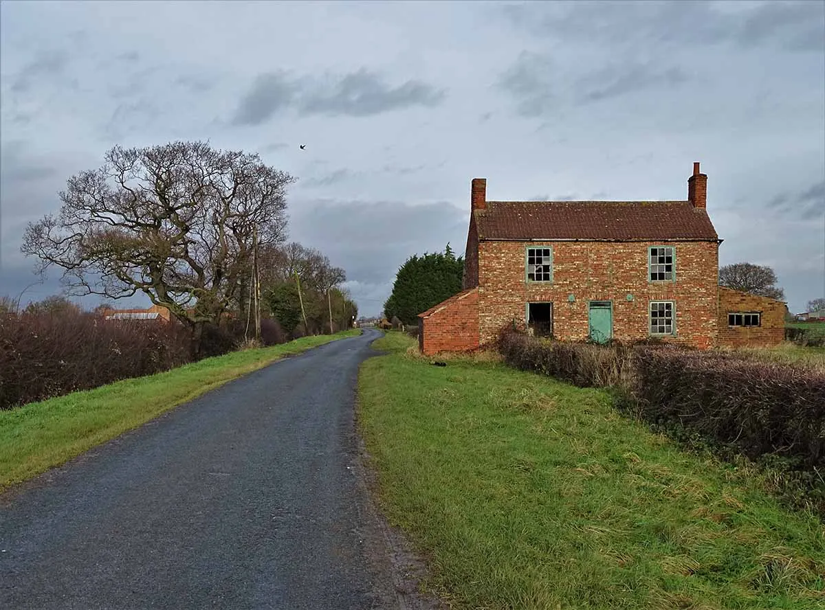 Photo of a repossessed house in the countryside in need of renovation.