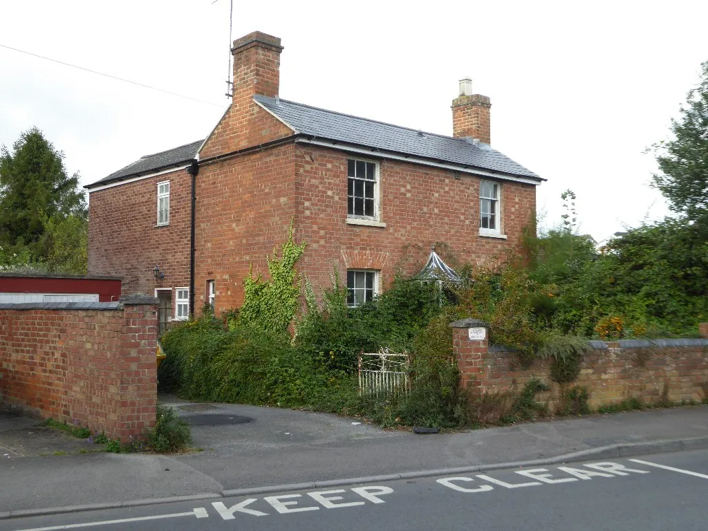 Photo of a house with an overgrown garden