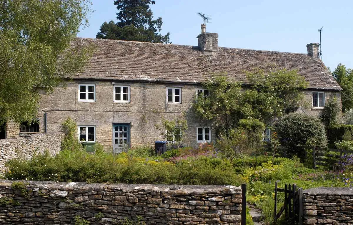 Photo of a stone cottage with rising damp issues in the walls.