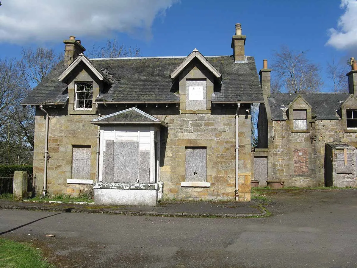 Photo of two repossessed houses for sale which are part of a former hospital building.
