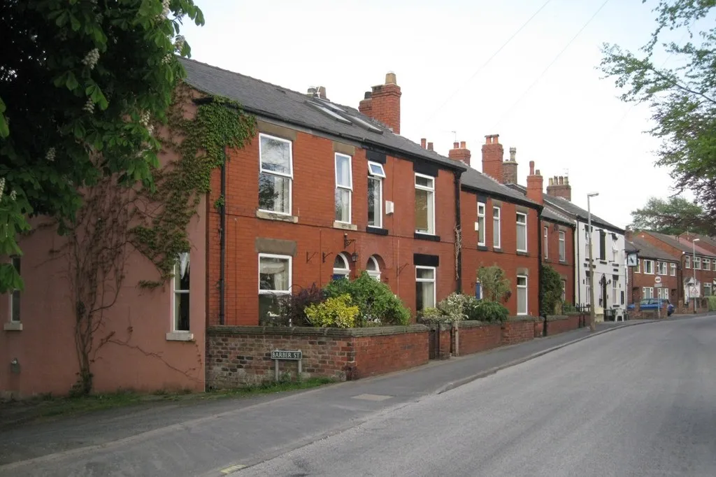 Photo of a street with brick houses