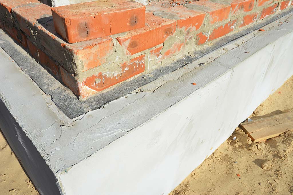 Photo showing a damp proof membrane and damp course ina  brick house.