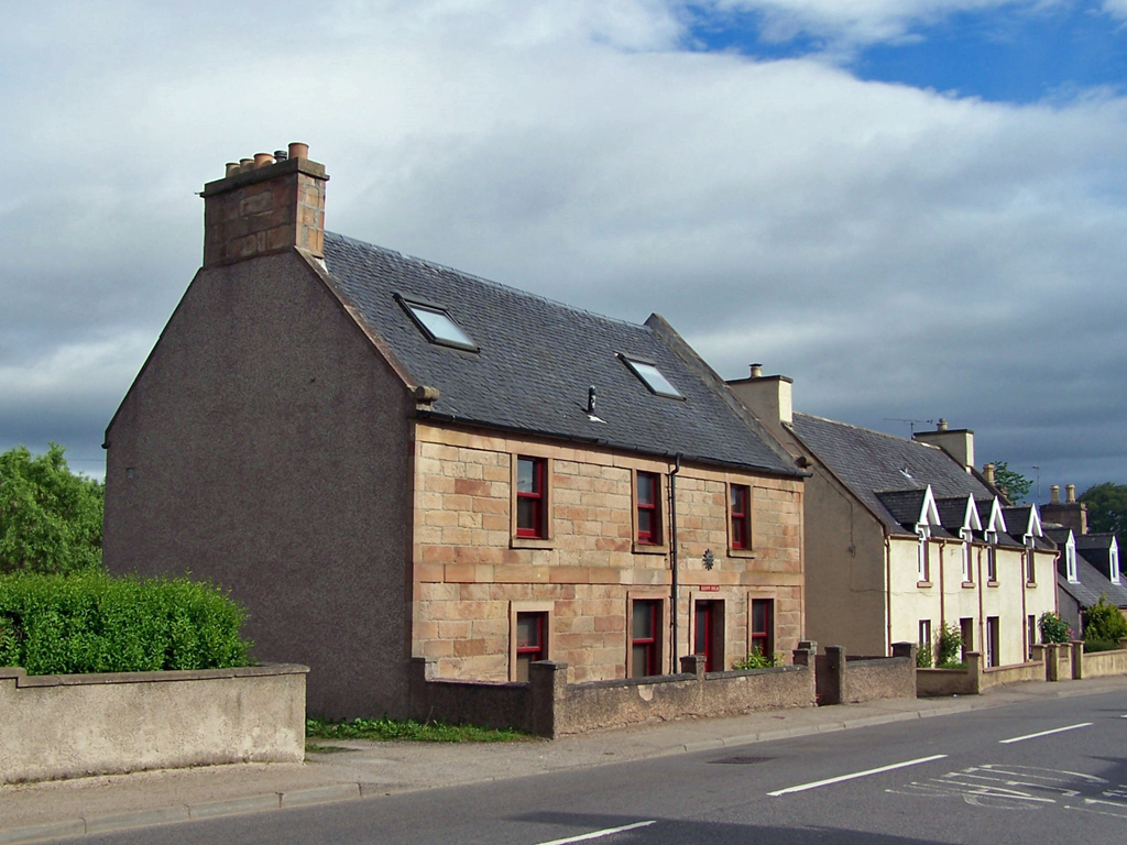 Photo of an old stone house with new double glazing